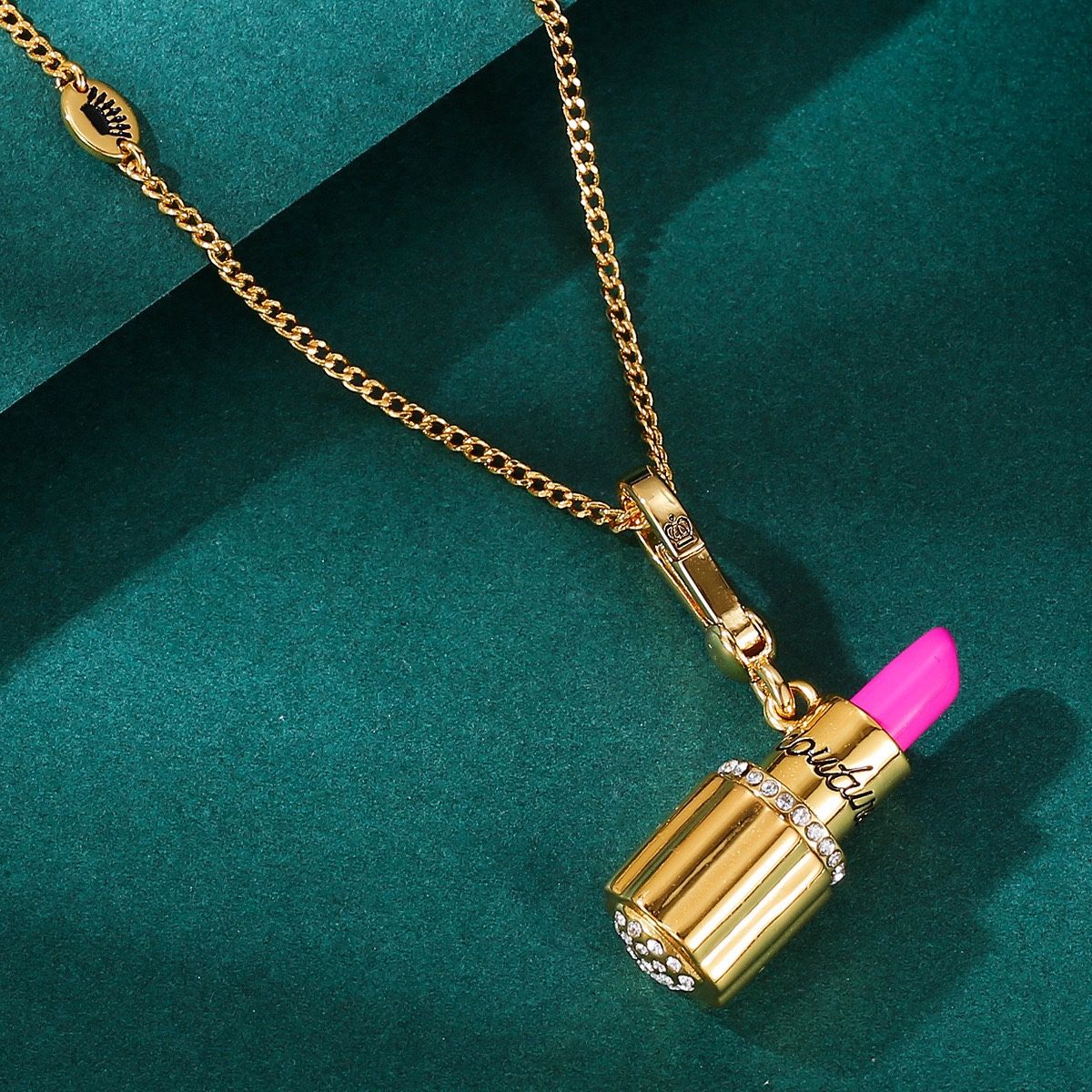 The Juicy Enamel Diamond-Studded Heart-Shaped Gold Tube Lipstick Necklace Pendant is a unique and exquisite piece of jewelry that combines fashion and