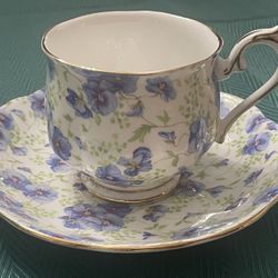 Royal Albert bone china teacup and saucer with blue pansy chintz pattern.