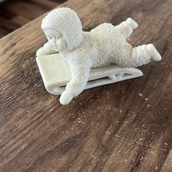 Snow Baby On A Sled