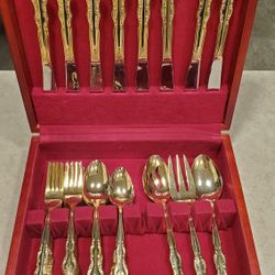 Gold tone International stainless silverware with storage box
