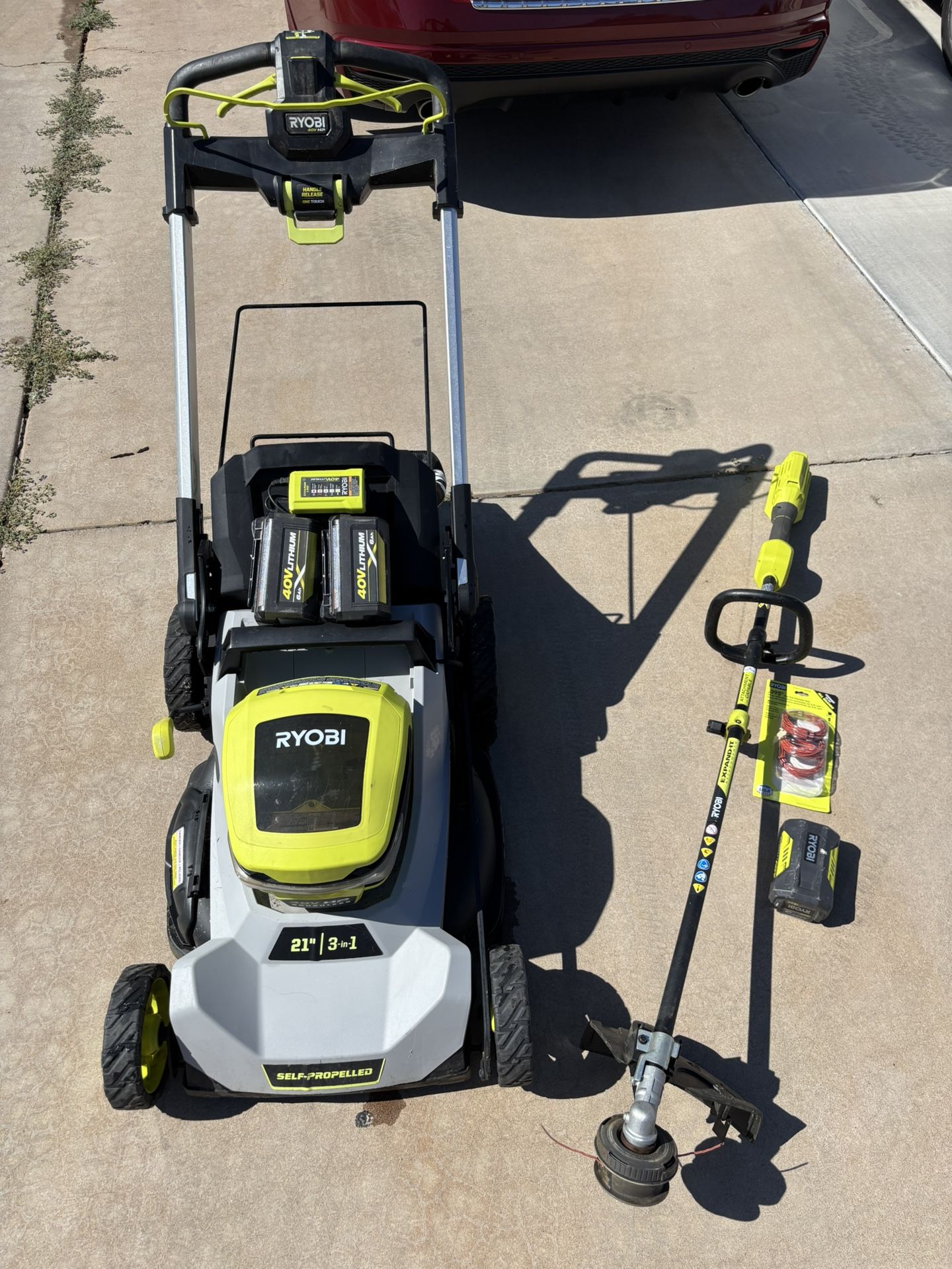 Ryobi 40 V self-propelled lawn mower 21” blade and adjustable 40v weed wacker trimmer