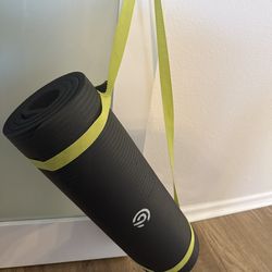 Black yoga mat with strap