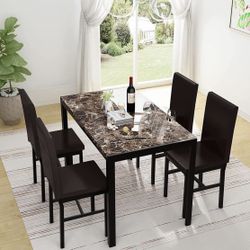 Marble dining tables with four chairs, like new.