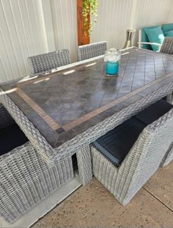 Beautiful Outdoor Tile Top Resin Wicker 7-piece Dinning Set.
