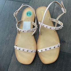 Tan sandals with pink and gold