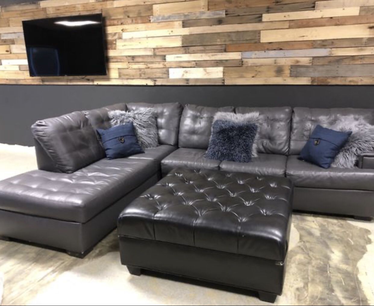 Grey sectional with black ottoman