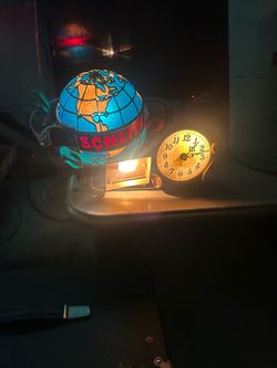 Schlitz beer globe/clock in good condition. Keeps time. Needs a small piece of glass or plastic in the front where the lightbulb goes. The blue globe 