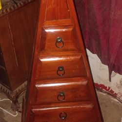 Pyramid dresser with 6 drawers. Dark wood.