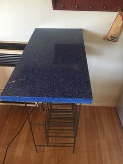 Countertop, blue recycle glass with wine rack below
