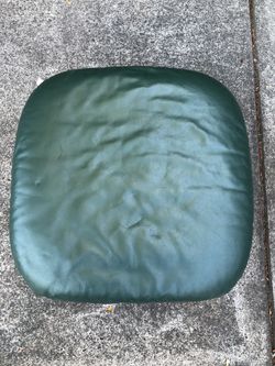 Green leather ottoman.