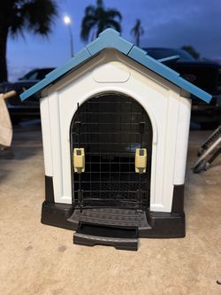 Plastic Outdoor Dog House with Wire Door.