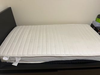 Twin bed with wood frame head board