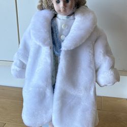 Porcelain Doll, 17” Tall, White Fur Like Coat, Blue Floral Dress, Long Blonde Curly Hair.