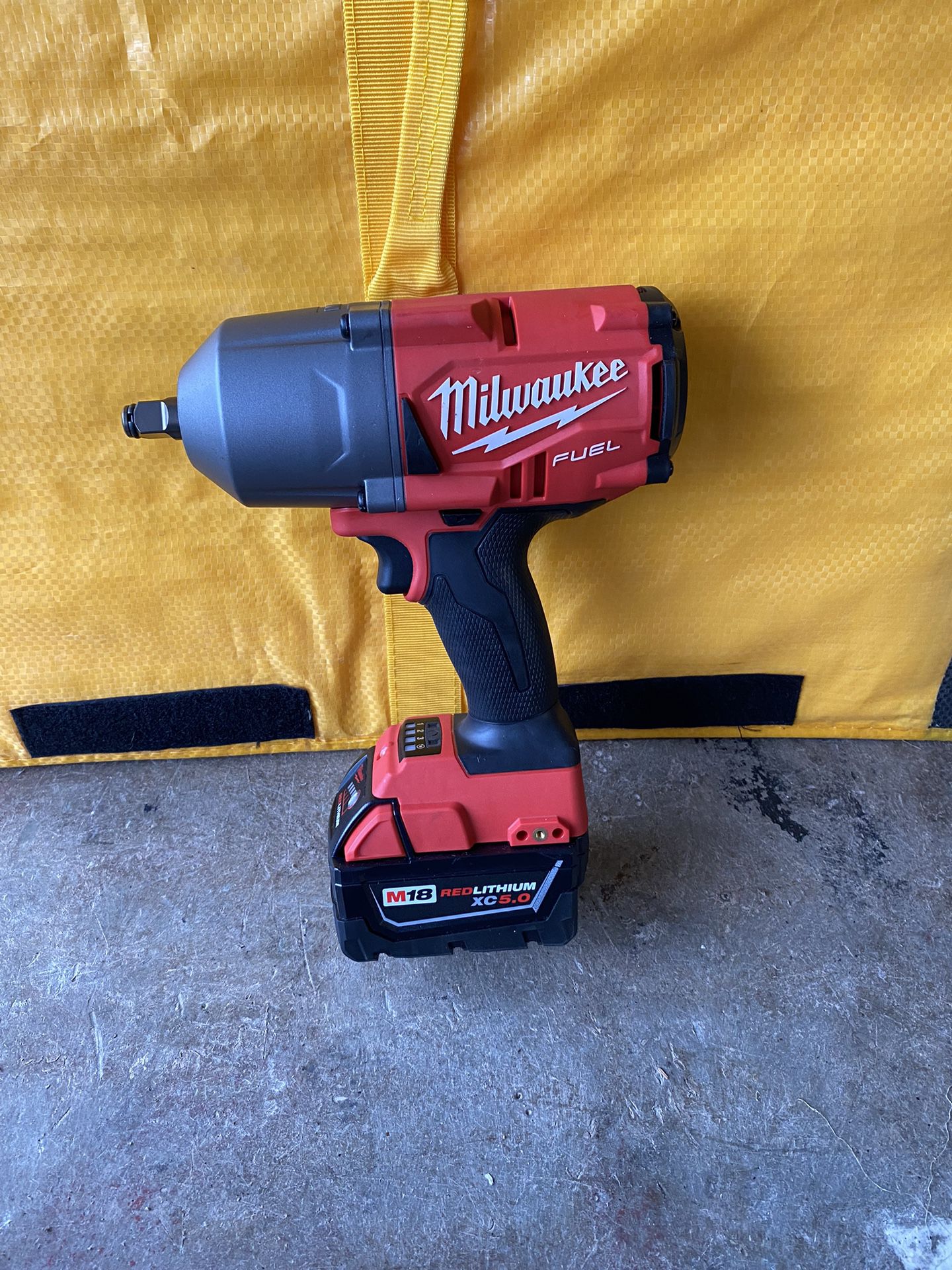 Milwaukee, 18 V half-inch impact wrench with 5.0 battery.