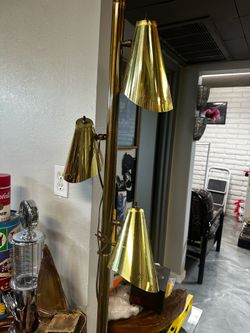 Mid-Century Modern brass tension pole lamp featuring three adjustable cone-shaped shades