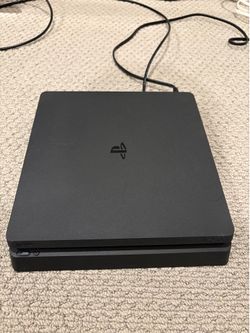 PS4 with two controllers and a charger