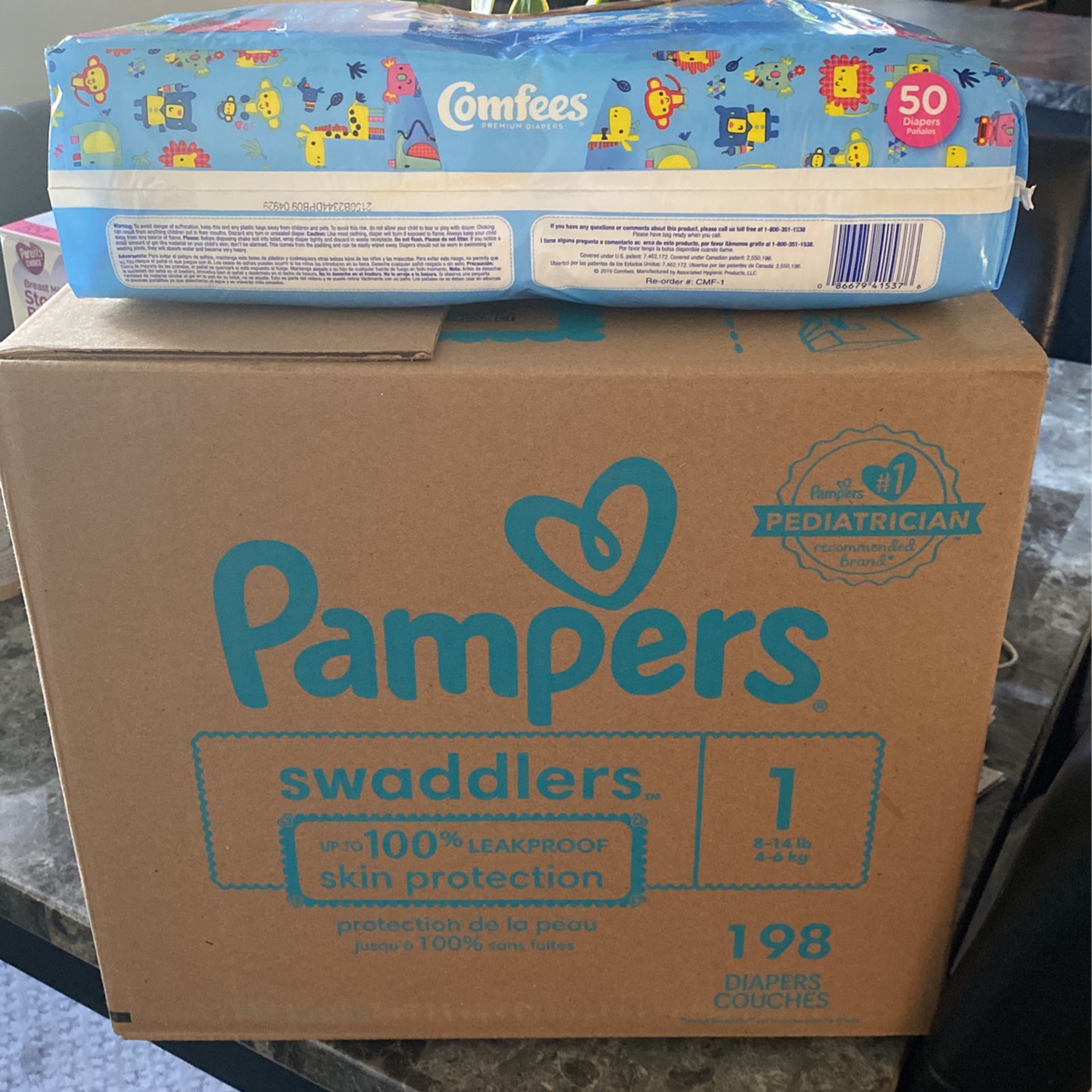PAMPERS and COMFEES Size 1 Diapers.