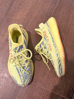 Adidas’s Yezzy yellow Sneakers with Blue Pattern