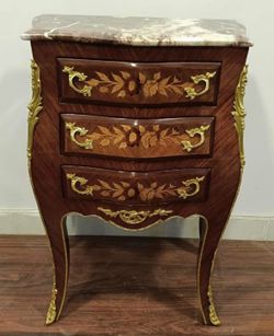 A Louis XV style commode with marble top and marquetry inlay. TIME PERIOD 19th Century ORIGIN France ESTIMATED VALUE I estimate this Louis XV style co