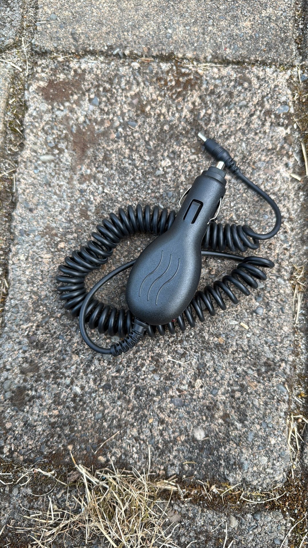 car charger or DC power adapter designed to charge electronic devices in a vehicle