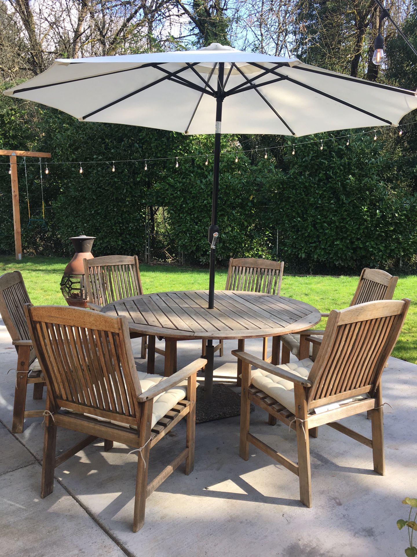 Round teak wood table, chairs and umbrella