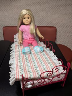 American girl doll and metal doll bed