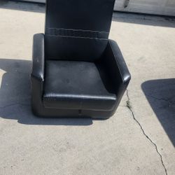 Used small black leather ottoman 