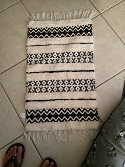 Black & White Geometric Wilshire Bath Rug features black and white cords. This Geometric Wilshire Bath features black and white cords woven into geome