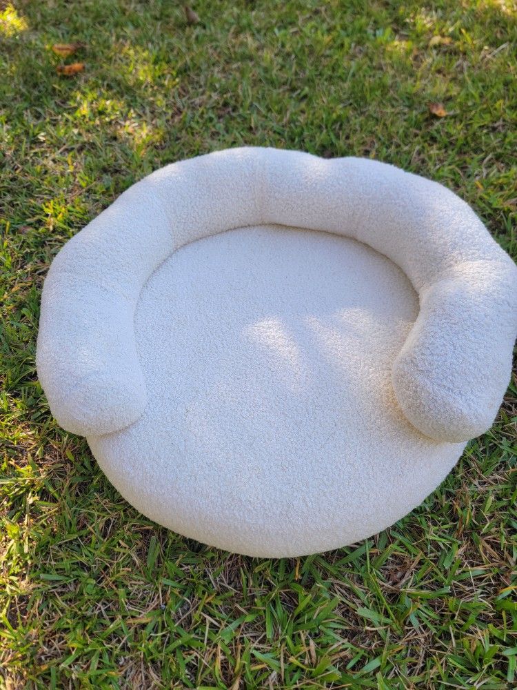 Round, bolster-style pet bed for small dog or cat