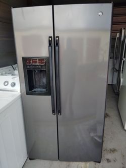 GE refrigerator side by side with water and ice