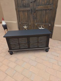 Black side table with glass on doors