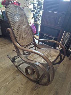 Vintage Thonet-style bentwood and woven cane rocking chair with a gracefully curved wooden frame