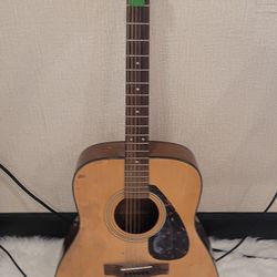 Yamaha acoustic guitar plays well has new strings