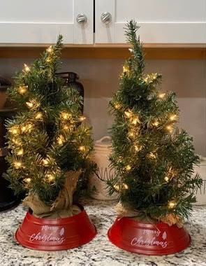 Pre-lit tabletop artificial Christmas trees with burlap bases 22” high with metal tree collar$20 for both must pick up