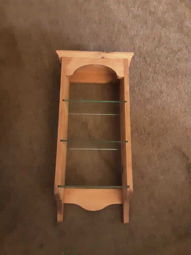 Light Colored Wood Shelf With Three Glass Shelves