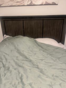 Bed frame with mattress and painting