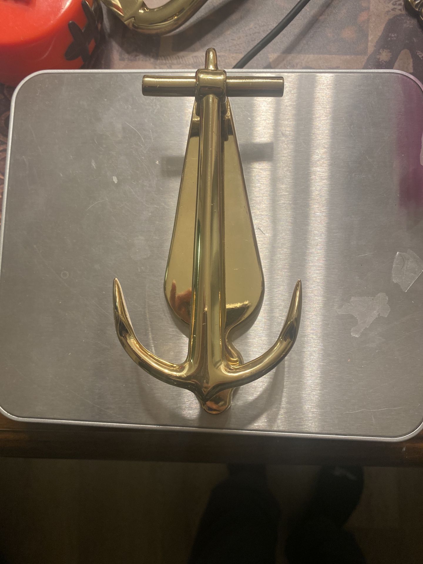 Shiny brass anchor door knocker