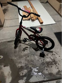 Red Huffy Rock It 16-inch sidewalk bike has a steel frame.