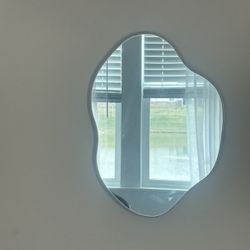Modern asymmetrical wall mirror with a soft wavy shape