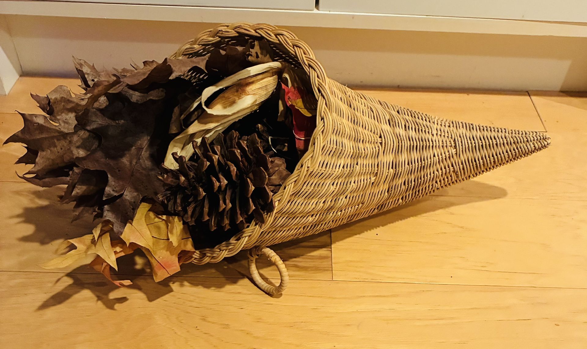 Cornucopia Arrangement Filled with Dried Leafs, Pine Cones, 18” Tip to Tip.