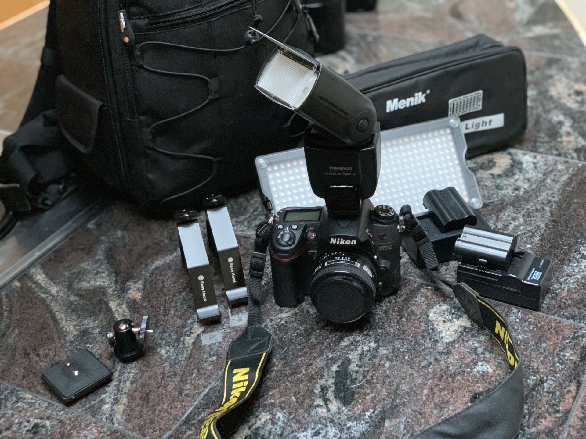 Photographers package -Nikon D7000 camera, 50 mm lens, yongnuo speedlight YN560, camera bag, Menik LED video light, 2 batteries & AC chargers