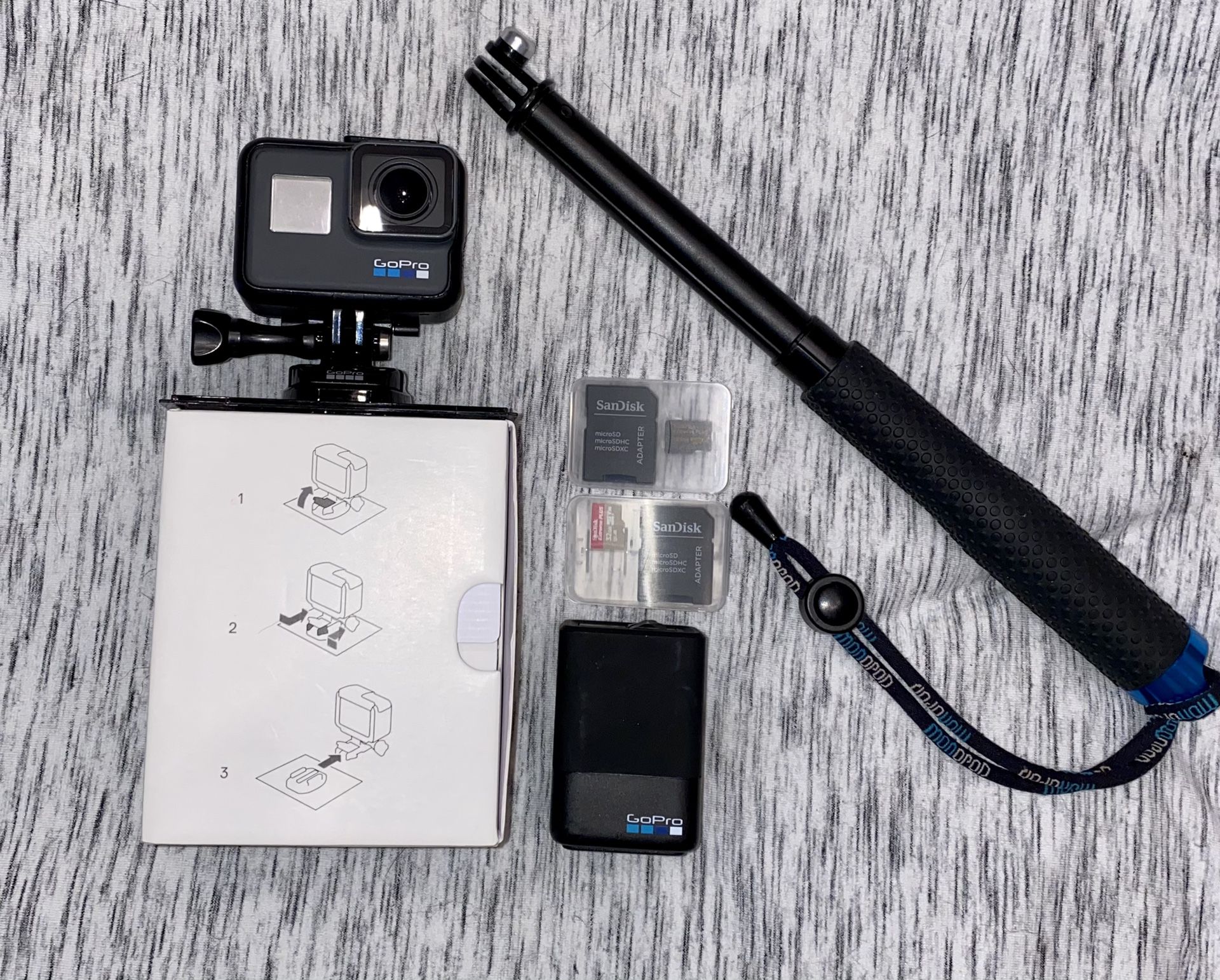 GoPro Hero 6 w/ extra battery, charging case, selfie stick, and 2 SD cards