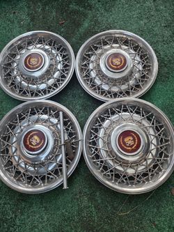 4 Cadillac hub caps with center emblem