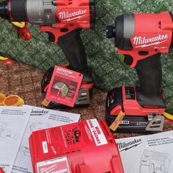 MILWAUKEE  M18 FUEL  18-VOLT LITHIUM ION  BRUSHLESS CORDLESS GEN-4  HAMMER DRILL AND IMPACT DRIVER  WITH TWO HIGH CAPACITY  5.0AH BATTERIES  AND CHARG