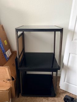 TWO BLACK GLASS END TABLES