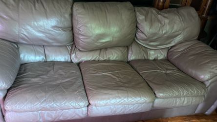 Free leather couch with metal coffee table and side lamp table