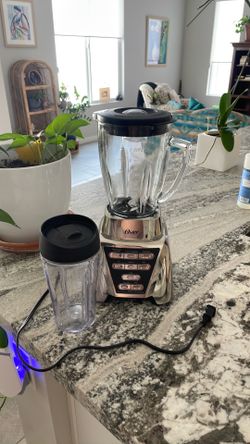 Oster blender with smoothie cup attachment.