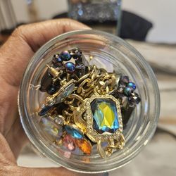 Jar of jewelry with iridescent jewelry