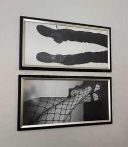 A pair of Black and white framed art with glass.