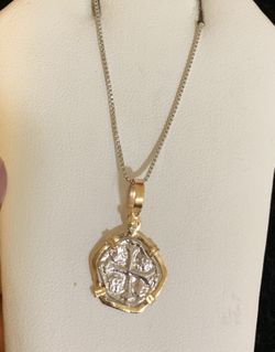 Atocha silver coin pendant in gold bezel with silver chain.